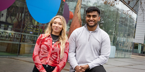 Female and male student stood outside we the curious in Bristol